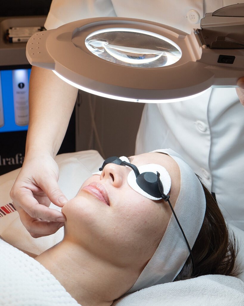 Hydrafacial treatment under a magnifying lamp at N.Bar Qatar in The Gate Mall, Doha